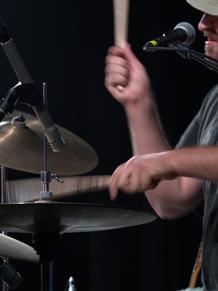 SteadyShot image stabilization allowed for a shutter speed slow enough to blur the sticks but keep the microphone sharp. Sony a6500—Exposure: 1/50 second at f/8.0, ISO 800