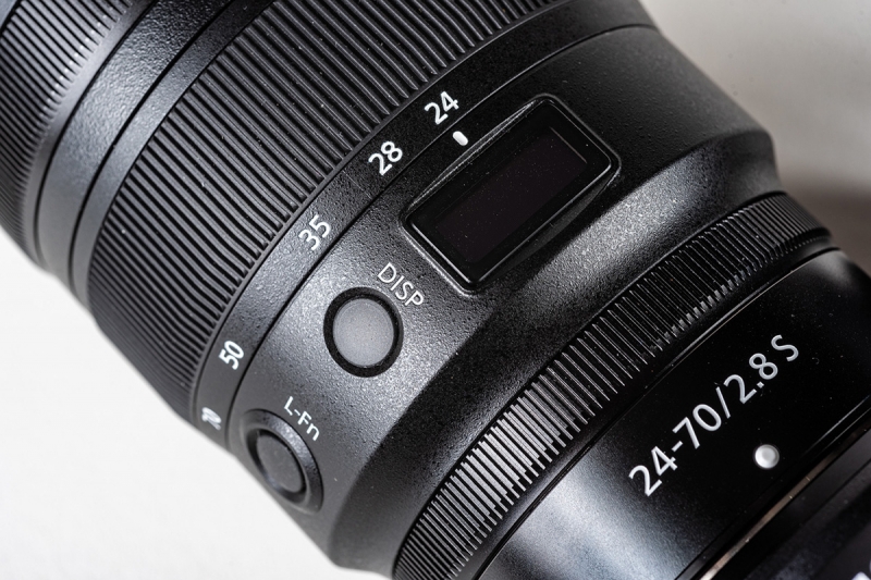 The DISP (display) button controls what you see through the window on the lens.