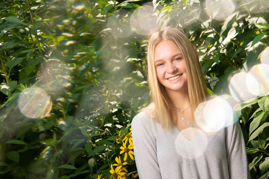 Portrait of a young person using a Lensbaby Omni filter that creates circular lens flare