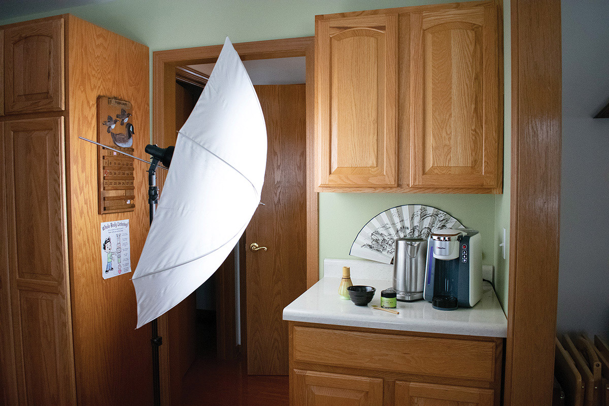 A StellaPro CL 2000 light with translucent white umbrella lights a still life on a kitchen counter