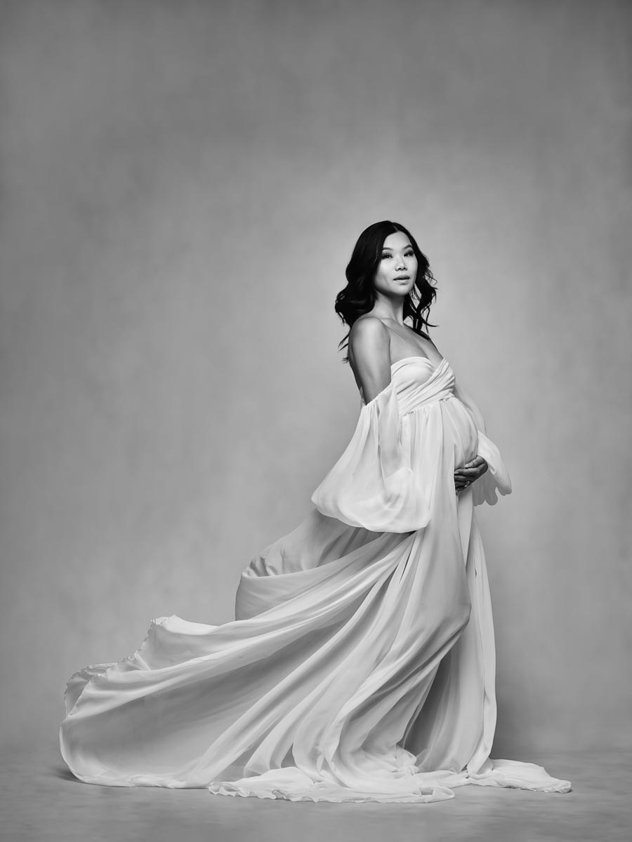 black and white maternity portrait with flowing white dress