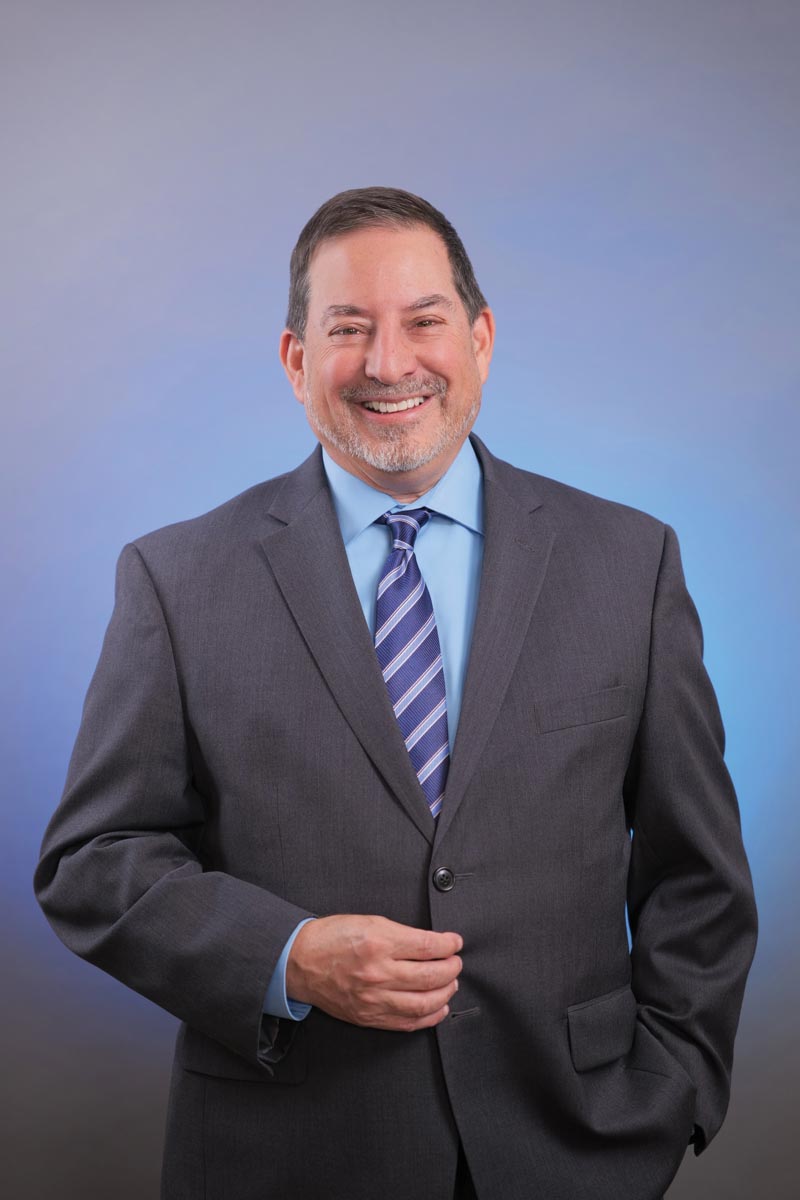 man wearing gray suit on a blue background