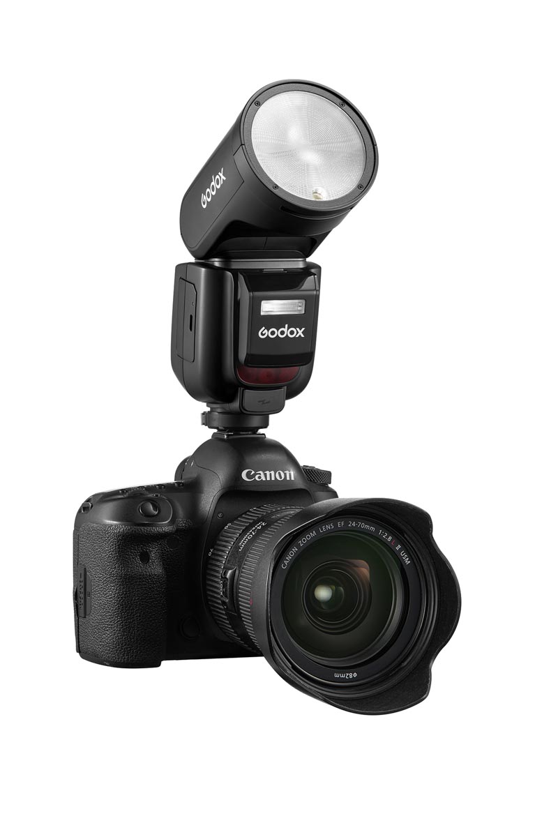 A Godox V1Pro flash is attached to a Canon camera body and lens. The height of the flash is significantly taller than the camera body.