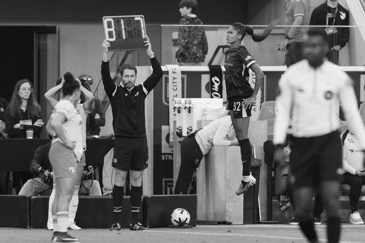photo of Sveindís Jane Jónsdóttir jumping high into the air on the sidelines of an Angel City FC, L.A.’s National Women’s Soccer League game