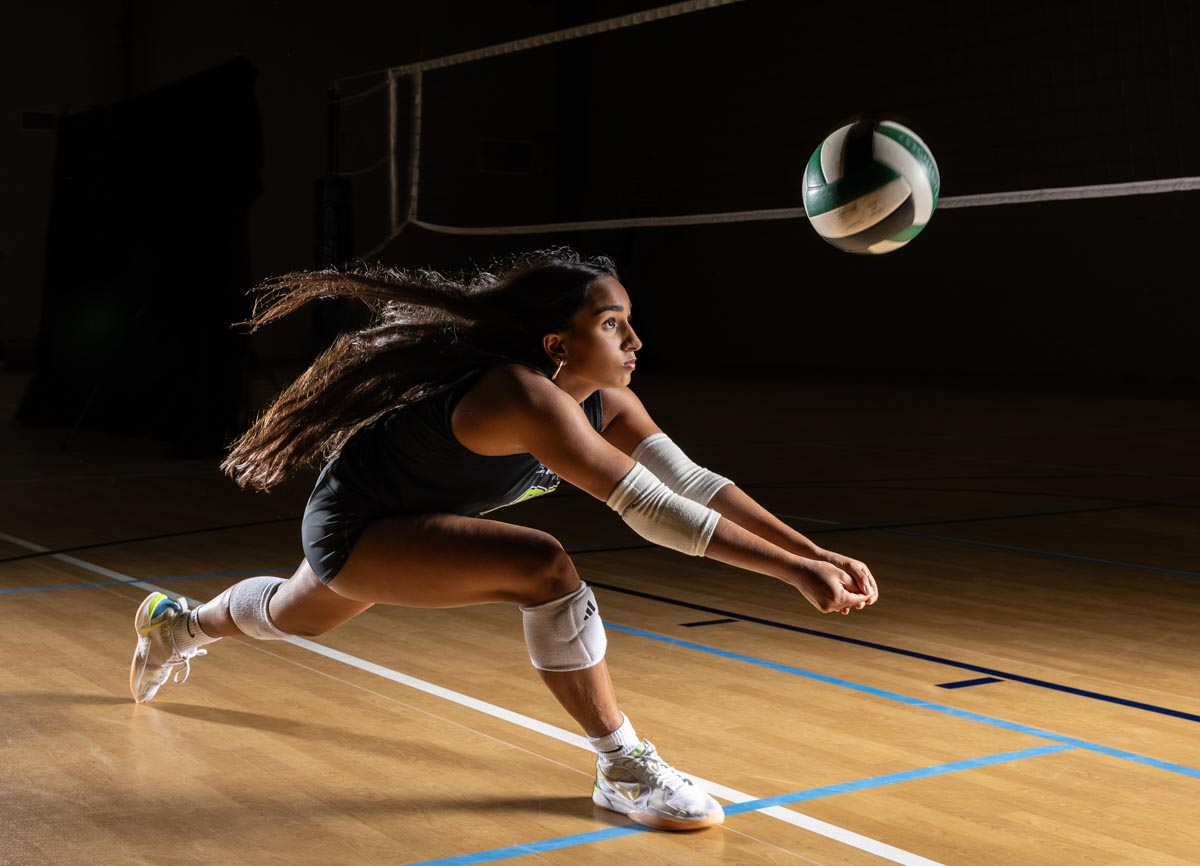 a volleyball player diving to bump the ball