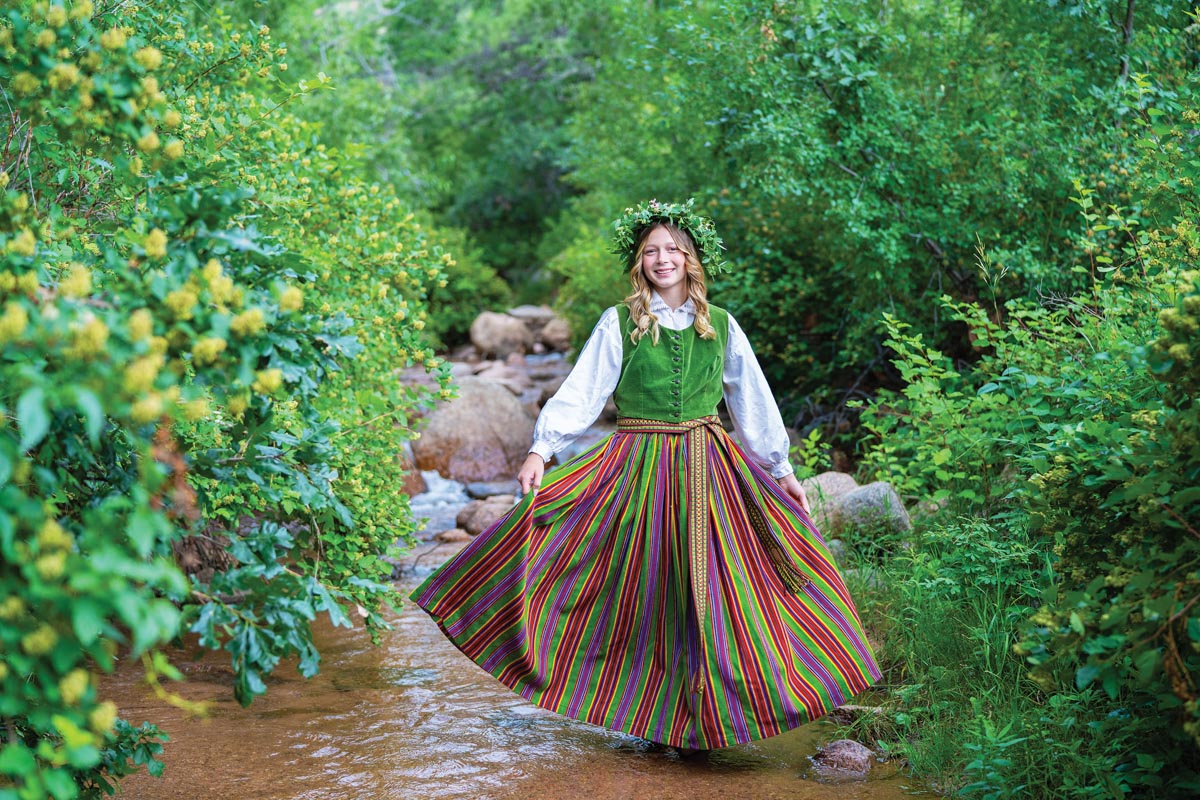 high school senior portrait of a girl standing in a stream