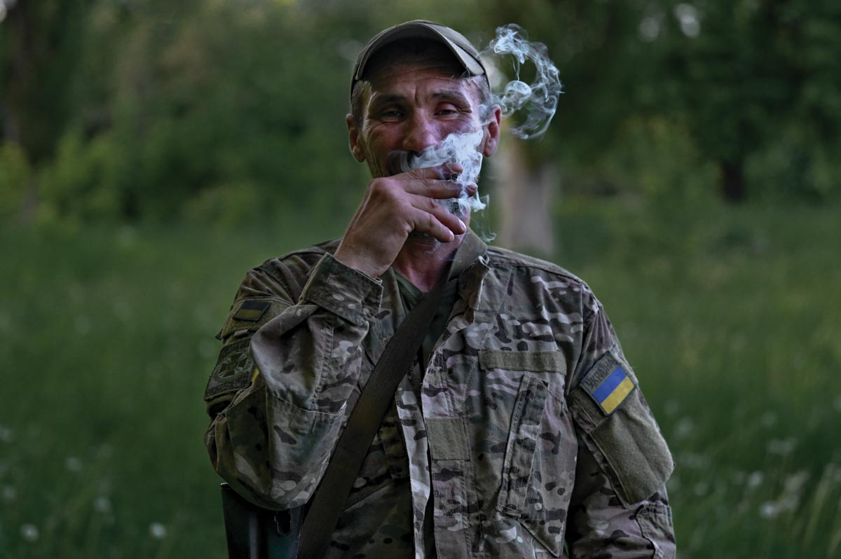 man in Ukrainian military uniform smoking