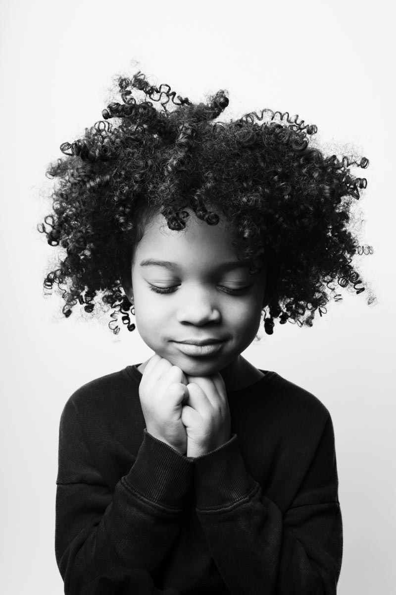 black-and-white portrait of a child with eyes closed 