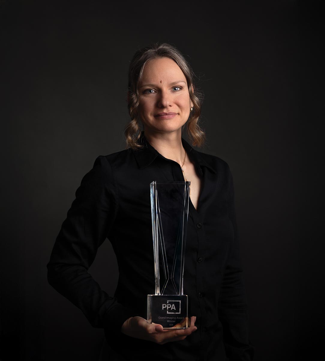 Sveta Butko holds her PPA IPC Grand Imaging Award trophy