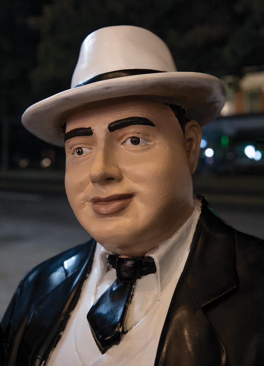 A painted statue of the likeness of Al Capone looking a little crudely done