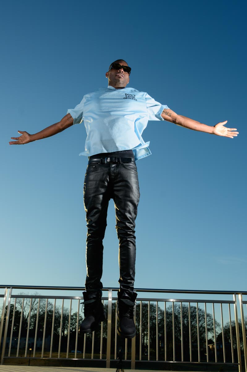 man with arms outstretched hovering in the air 