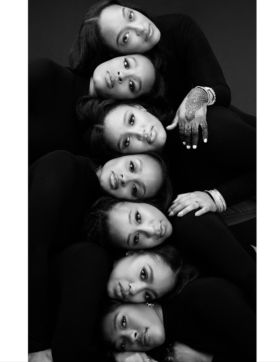 black-and-white photo of seven women's faces lying on top of one another 