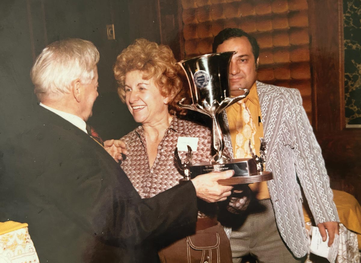 vintage photo of PPA member Florence Bendall receiving a trophy from a man wearing a suit