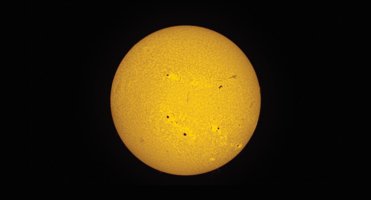yellow planet with satellite in front of it